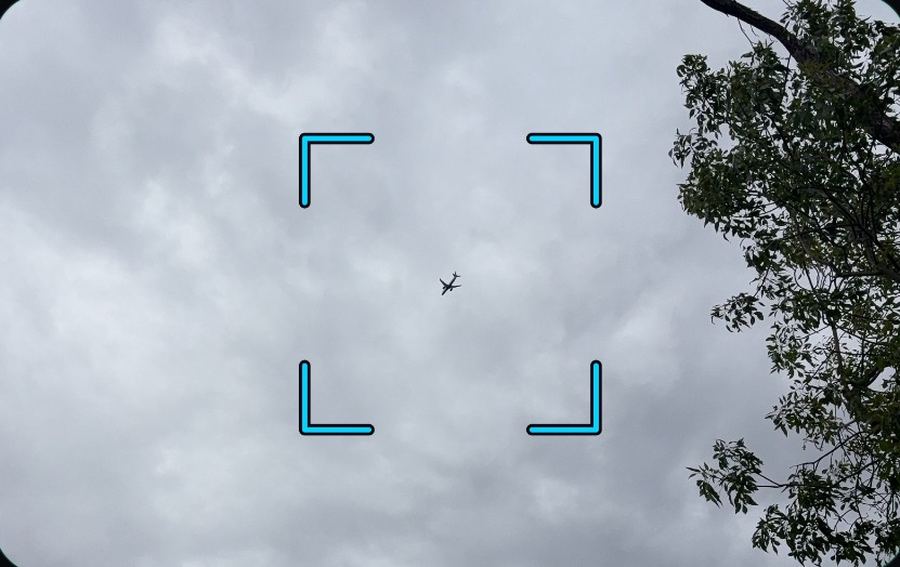 An Airbus A220 below breaking cloud