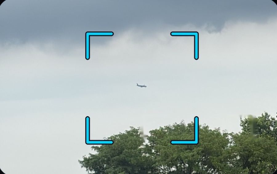 A Boeing 767 against a dark cloud band